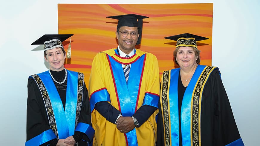 Three people posing for a photo.