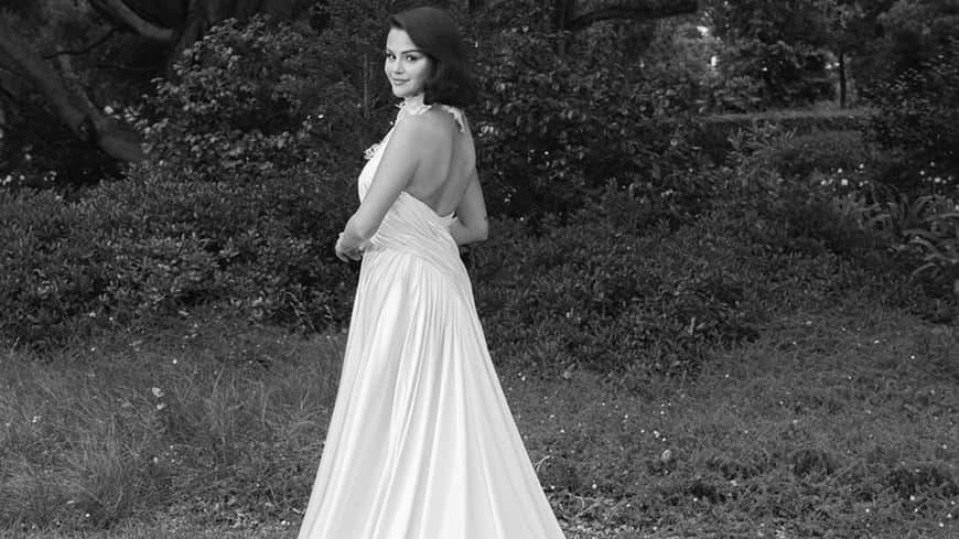 A woman posing in her wedding gown