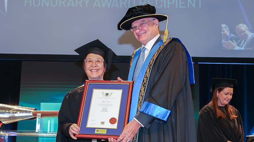 Two people getting an award.