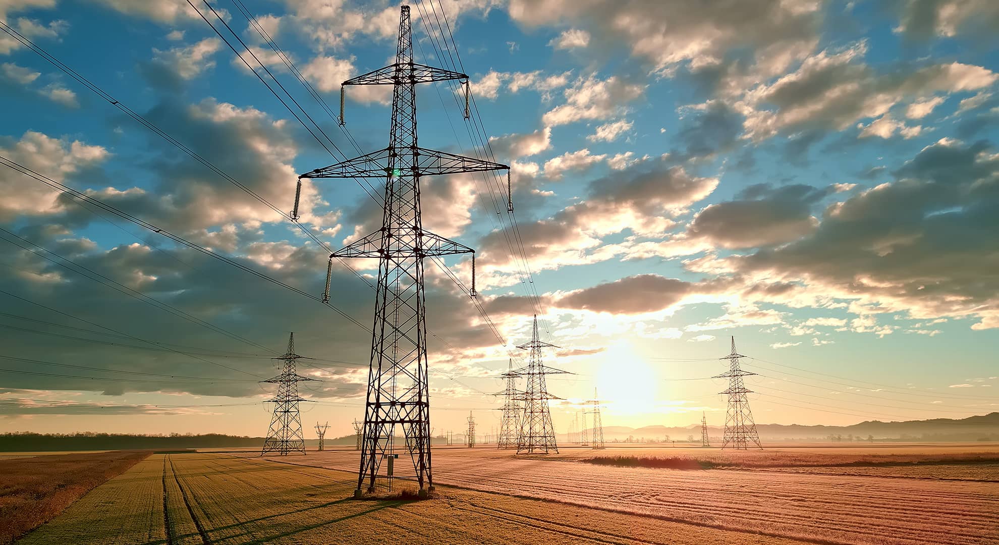 Power lines against a sunset.