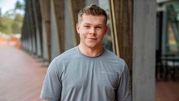 Man facing camera on ECU campus